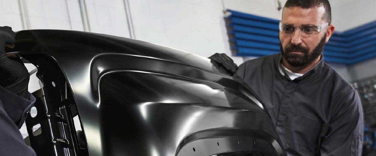 Technician removing vehicle parts